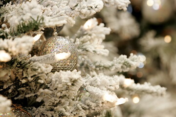 Close-up of Christmas tree decoration with white, silver and bronze shades. Christmas and New Year decorated interior