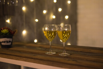 two glasses of champagne are on the bar