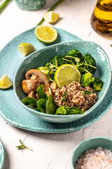 Quinoa with spinach and mushrooms in a bowl, healthy vegan lunch bowl, banner, catering menu recipe, top view, Clean eating, dieting, vegan food concept. vertical image