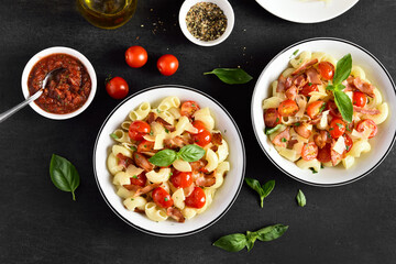 Pasta with bacon, tomato, parmesan cheese and basil leaves