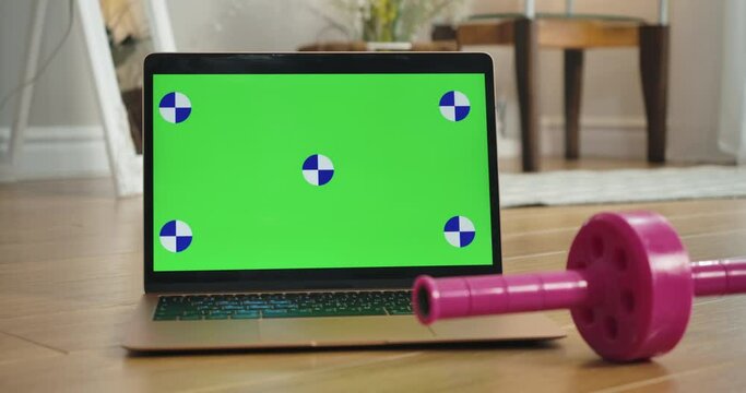 Chromakey screen on laptop with unrecognizable Caucasian woman taking measuring tape from the front. Sportswoman training using web page with video lesson online. Cinema 4k ProRes HQ.