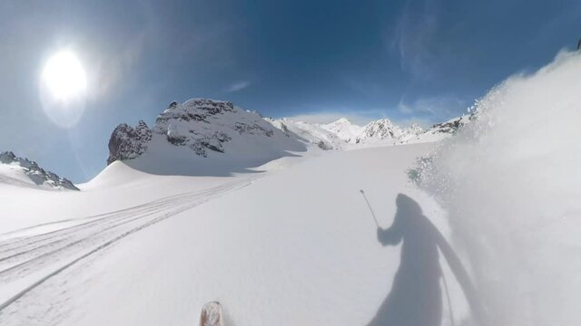 POV: Shredding virgin powder snow while riding off trail in the scenic white Canadian Rockies. Cool first person shot of snowboard touring in the Rocky Mountains on a picturesque sunny winter day.