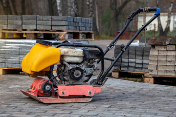Vibrating plate compactor machine at a construction site. Equipment for soil thrombosis. Compaction...