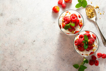 Layered yogurt, granolla and fruits, strawberry ans raspberry. Healthy breakfast. Top view, copy space.