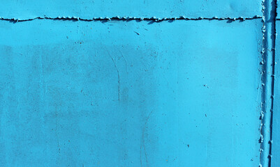 blue metallic background. Old metal plate painted bright blue
