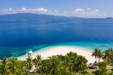 Perfect white sand beach with tropical trees. Mahaba Island, Philippines.