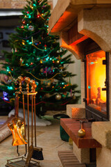Set of tools in front of fireplace. Behind Christmas tree
