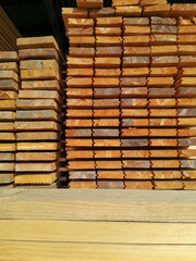 Lumber in large warehouse. Wooden boards in the stack. Edged board. Storage. Close-up. Selective focus.