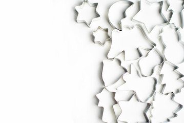 Fototapeta premium Forms for cookies and gingerbread on a white background lie on the right, place for text on the left