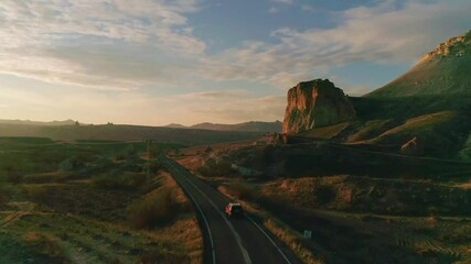 car traveling at sunset at a cinematic landscape