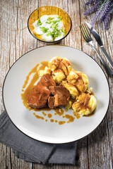 Braised pork neck in own sauce served with boiled potatoes.