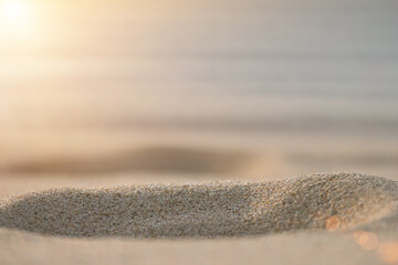 Sand close up. Blurred background in the distance. Sunny evening on the shore