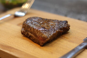 grilled steak on a wooden board