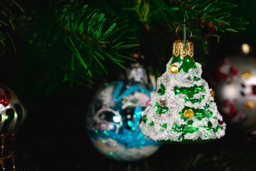 Vintage glass spruce on Christmas tree. Merry xmas and Happy New Year cliseup background