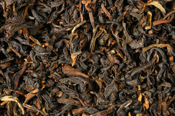 Black loose dry indian tea from Darjeling, India. Close-up macro high resolution background..