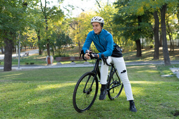 a young man of European appearance sat down on a bicycle frame. active lifestyle.