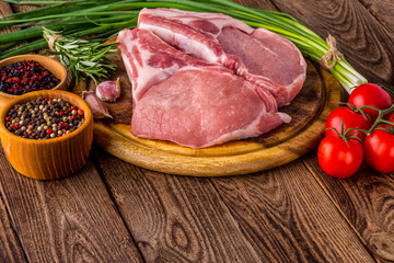 fresh raw new-york steak on wooden Board on wooden background with salt and pepper in a rustic style.