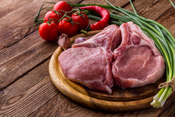 fresh raw new-york steak on wooden Board on wooden background with salt and pepper in a rustic style.