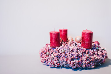 Red advent and Christmas wreath with candles and beautiful dry decoration