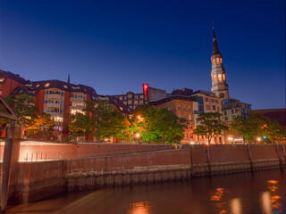 Naklejka premium Hamburg City night scene with warm colors during summer time and blue sky background
