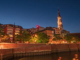 Fototapeta premium Hamburg City night scene with warm colors during summer time and blue sky background
