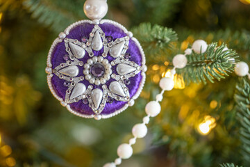 closeup of christmas holiday single ornament hanging on tree