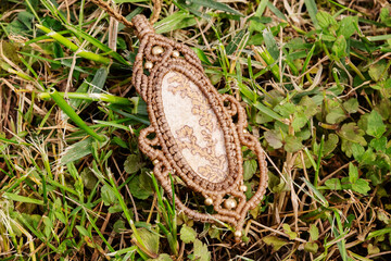 Mineral gemstone ornamental pendant on natural background