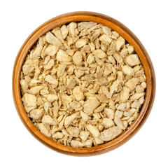 Ginger roots, cut and dried, in a wooden bowl. Pieces of dry ginger rhizomes, used as warming spice...