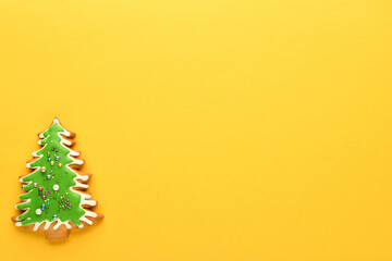 Christmas tree on a yellow background. Gingerbread in the shape of a Christmas tree. New year and Christmas background. Flat lay