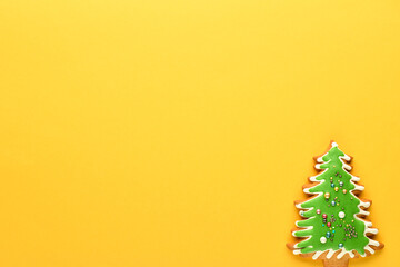 Christmas tree on a yellow background. Gingerbread in the shape of a Christmas tree. New year and Christmas background. Flat lay