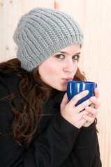 very warm woman in autumn or winter in a cabin