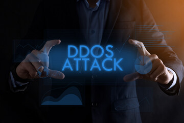 Business man hands holding inscription DDOS ATTACK with different graphs on the background.automation technology concept.