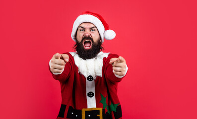 Fototapeta na wymiar bearded santa man in hat smiling while prepare for celebrating happy new year party and christmas holiday in winter going to have xmas gifts, pointing finger