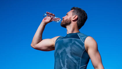 athletic man drinking water because of thirst after training, sport and health