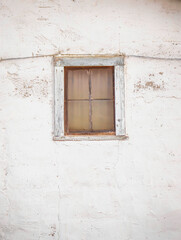 White wooden window frame, framed by a white plaster wall. Minimalism.