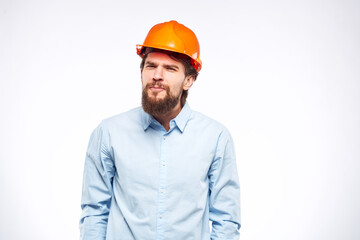 Man in orange hard hat industry engineer work professional light background