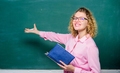 Pedagogue hold book and explaining information. Teacher explain hard topic. Woman school teacher in front of chalkboard. Teacher best friend of learners. Passionate about knowledge. Education concept - Powered by Adobe