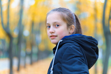 a girl posing and enjoying autumn in city park, beautiful nature with yellow leaves