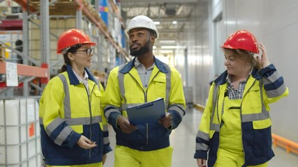 Warehouse workers team inspecting manufacturing storage - Powered by Adobe