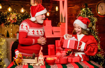 Cheerful celebration. Santa bring gifts little girl. Child enjoy christmas with bearded grandfather...