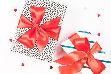Present, holiday, Christmas, white background. Two gift boxes with red satin bows on a white background. Festive concept. Isolated.