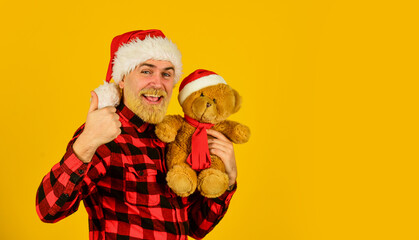 Kind hipster with teddy bear. Charity and kindness. Lovely hug. Santa Claus. Mature man with long beard. Christmas spirit. Christmas time for mercy. Charity project. Bearded man celebrate christmas