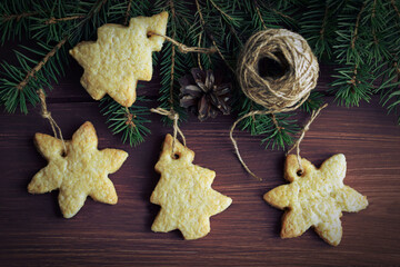 Homemade Christmas cookies and a Christmas tree on a wooden background.Winter holiday.