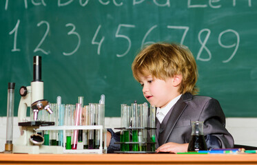 student do science experiment with microscope in lab. small boy at science camp. microscope at lab. small boy using microscope at school lesson. Back to school. Analyzing strategy