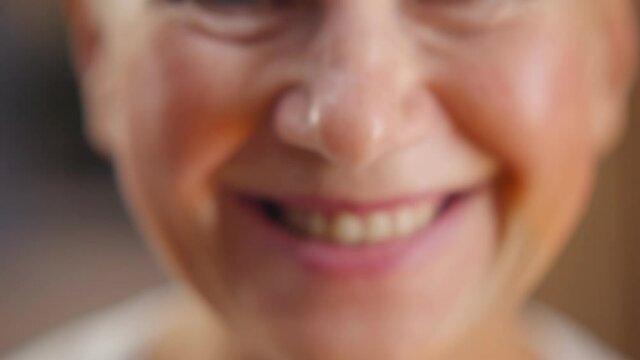 Close up portrait of cheerful mature woman smiling at camera