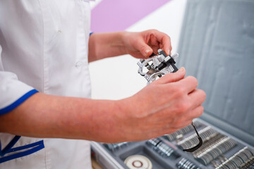 The ophthalmologist offers the patient glasses. Vision testing concept.