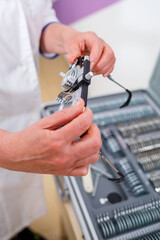 The ophthalmologist offers the patient glasses. Vision testing concept.