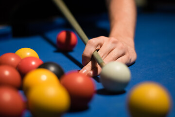 Detail of a persons hand playing pool