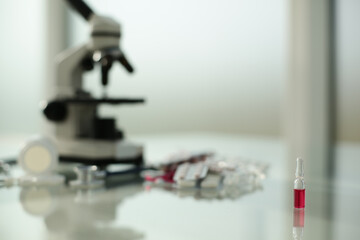 Stethoscope ampoule pill microscope on glass table