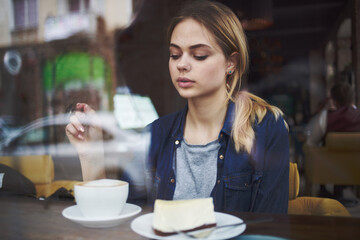 Pretty woman sitting at the table in cafe breakfast snack lifestyle 